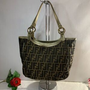 AUTHENTIC Fendi Tobacco Zucca Medium Chef Shopper Tote has been sewn on corners.